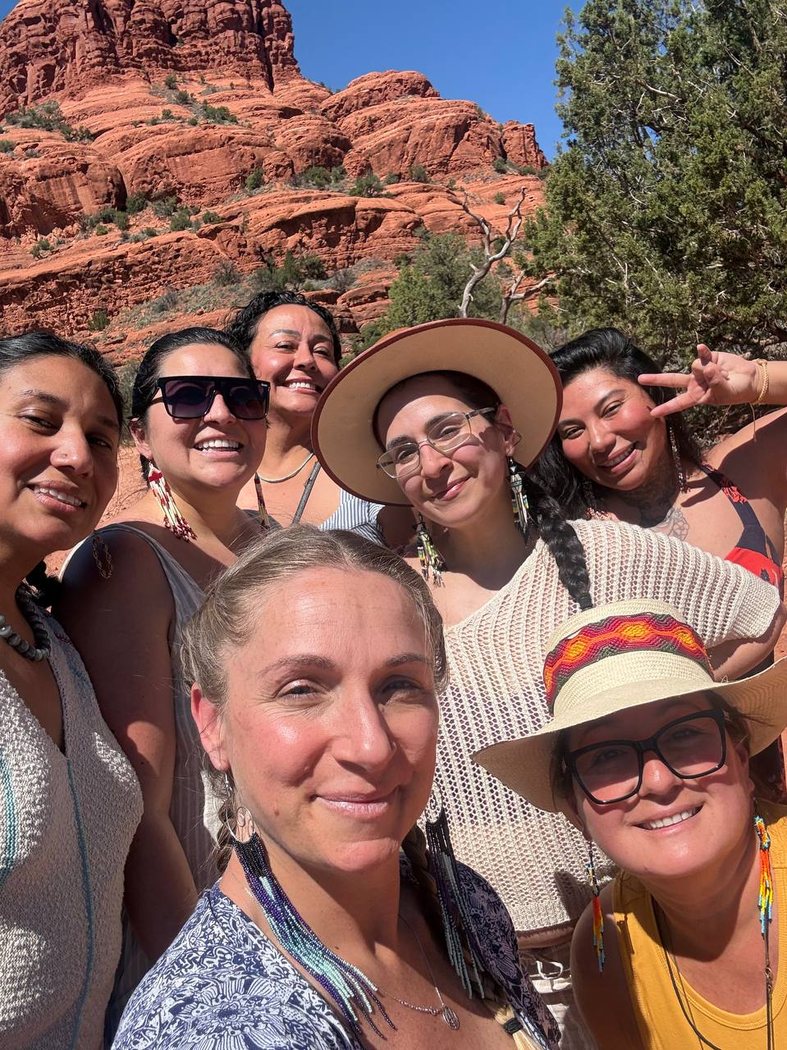 A close group selfie of women smiling in the sun